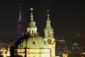 IlluminatSt Nicholas church and Prague Zizkov TV tower night photo in February 2025ed