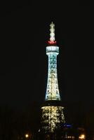 Illuminated Petrin tower during winter night in Prague Czechia in February 2025 photo