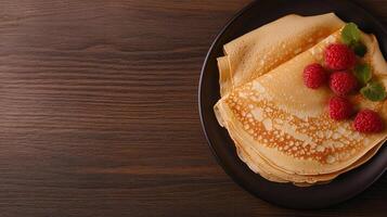 A plate with pancakes and raspberries on it photo