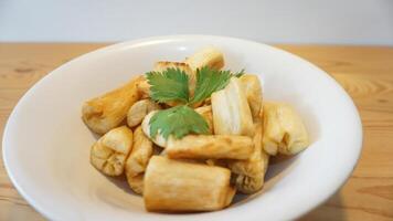 A bowl of cooked potatoes with a green leaf photo