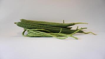 A pile of green okra on a white background photo