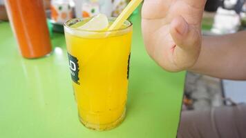 A person holding a drink with a straw photo