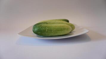 Three cucumbers on a plate photo