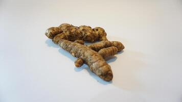 A ginger root on a white surface photo