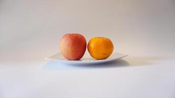 A white plate with two fruits on it photo