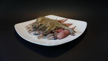 A plate with shrimp and other food on it photo