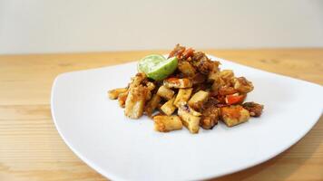 A plate of food with a lime wedge on top photo