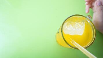 A person holding a glass of orange juice photo