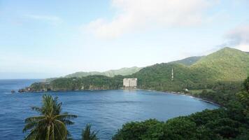 A view of the ocean and mountains from a hill photo
