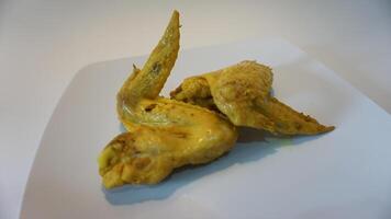 A white plate with chicken wings on it photo