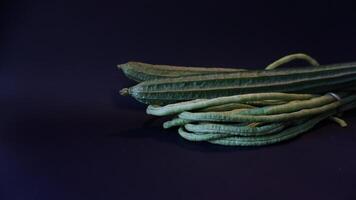 A bunch of green beans on a dark background photo