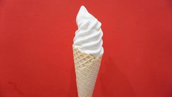 A cone of ice cream with a red background photo