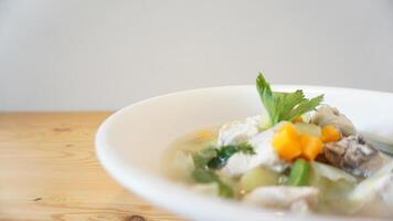 A bowl of soup with vegetables and meat photo