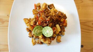 A plate of food with a lime wedge on it photo