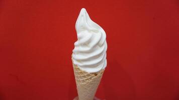 A person holding a cone with whipped cream on it photo