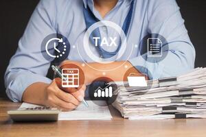 A businessman filing tax forms while sitting at the table photo