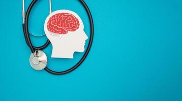 A brain shape symbol and a stethoscope on a blue background. Top View. photo