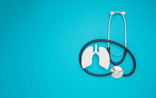 A lung symbol and a stethoscope are on a blue background photo