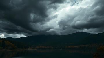 Lake Landscape with Dramatic Sky and Mountain Backdrop in Autumn photo
