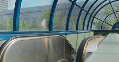 A view of a subway car with a window video