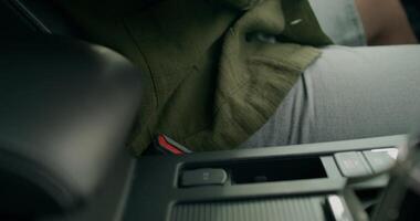 A person sitting in the driver's seat of a car video