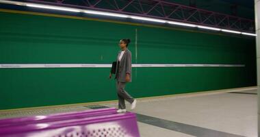 A man in a suit walks through a subway station video