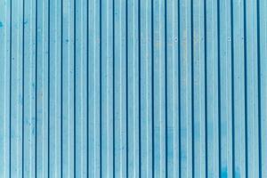 corrugated metal door with blue painted vertical lines, rich textured background for design photo