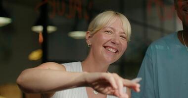 A woman smiling at a man while pointing at something video