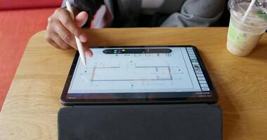 A person using a tablet to design a building video