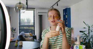 A woman is applying makeup in front of a mirror video