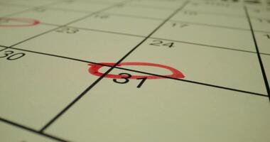 A calendar with a red circle circled on it video