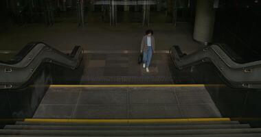 A person walking down an escalator in an empty building video