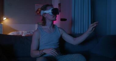 A man wearing a virtual reality headset in a dark room video