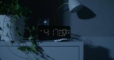 A clock with the time displayed on it in the dark video