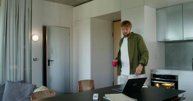 A man standing in front of a laptop computer video