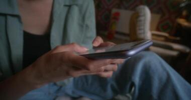 A person is using a cell phone while sitting on a couch video