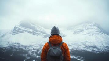 Hiker admiring inspiring winter mountain view in the fog photo