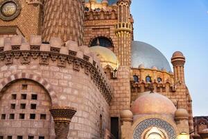 Exploring the intricate architecture of a historical building in Cairo during sunset photo