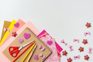 Crafting materials arranged for creative projects with colorful papers and decorative items photo