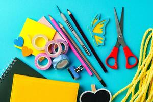 Craft supplies arranged on a vibrant blue background for creative projects and DIY activities photo