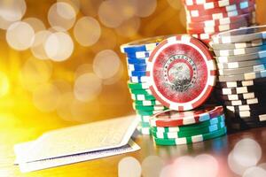 Poker chips stacks on bokeh light background photo