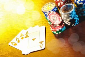 Poker cards and chips on blurred background photo