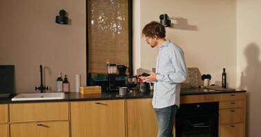 A man standing in a kitchen with a coffee maker video