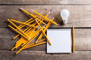 Lightbulb and blank open notepad. Having an idea concept photo