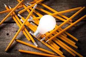 Composition of Light bulb with pencils. Creativeness concept photo