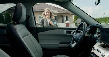 A woman is sitting in the driver's seat of a car video