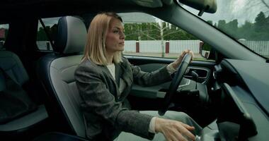 A woman driving a car with her hand on the steering wheel video