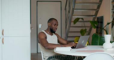 A man sitting at a table with a laptop video