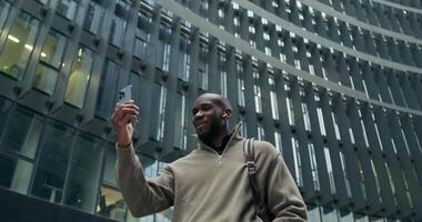 A man taking a selfie in front of a building video