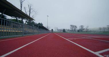 A running track with red lines and a person standing on it video